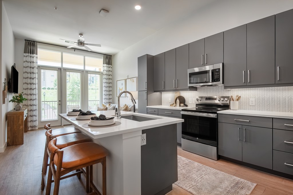 A modern kitchen with a dining table and chairs.