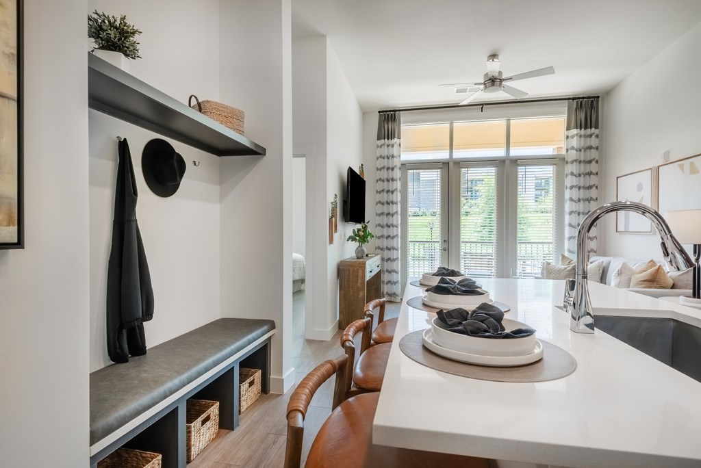 A modern kitchen with a dining table and chairs.