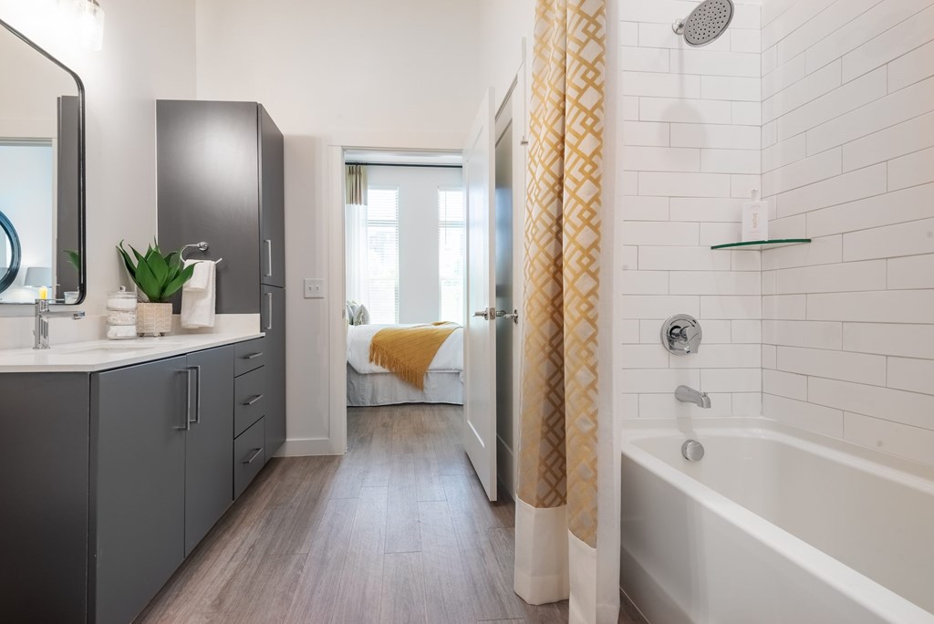 A bathroom with a white tub and a shower.