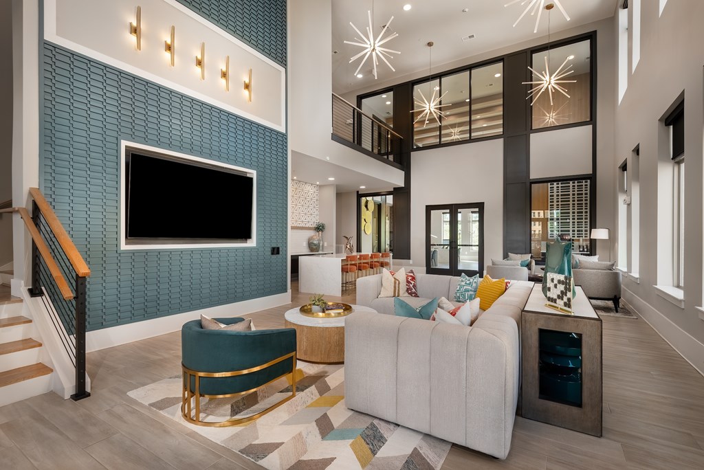 A modern living room with a white sofa and a blue accent wall.