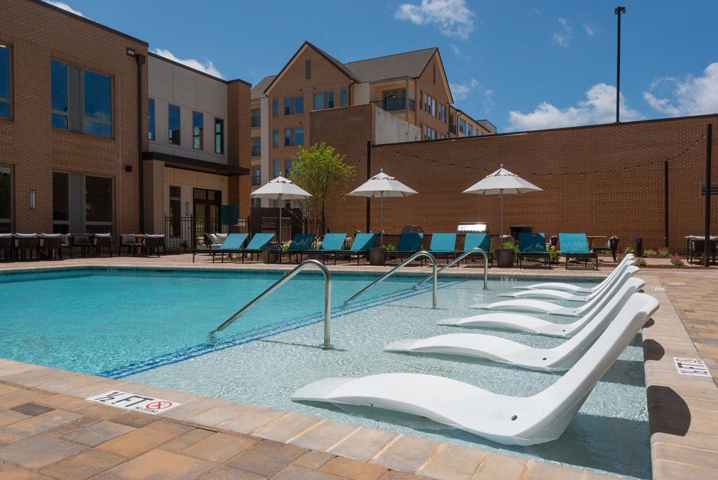 A pool with a white fence and a blue pool.