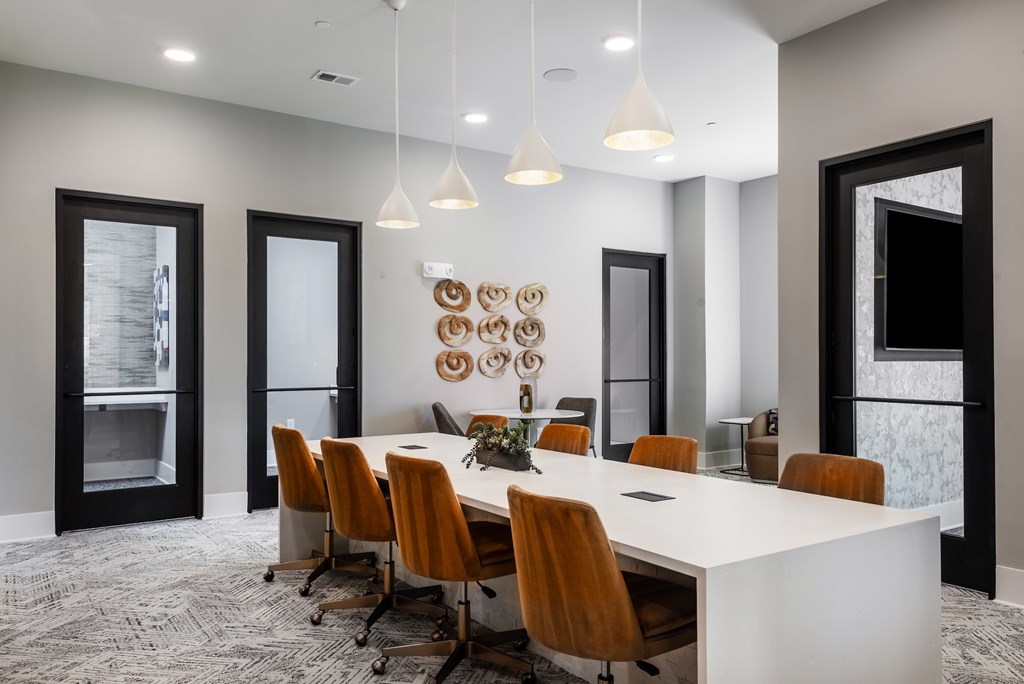 A conference room with a long table and chairs.