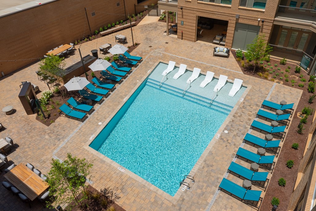 A large swimming pool surrounded by sun loungers.