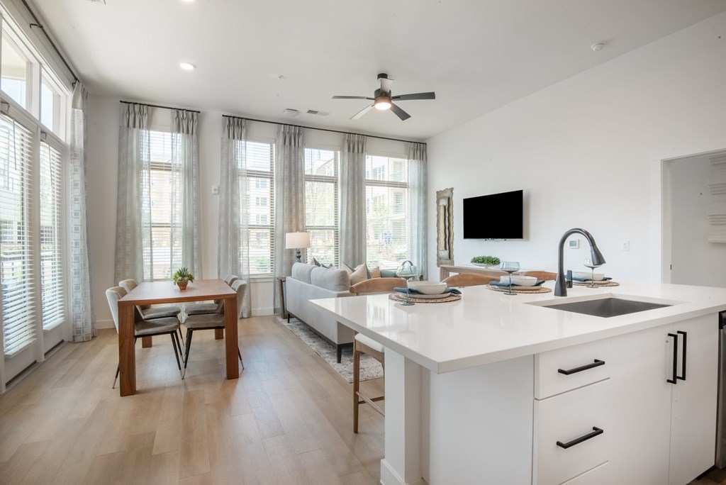 A modern kitchen with a dining table and chairs.