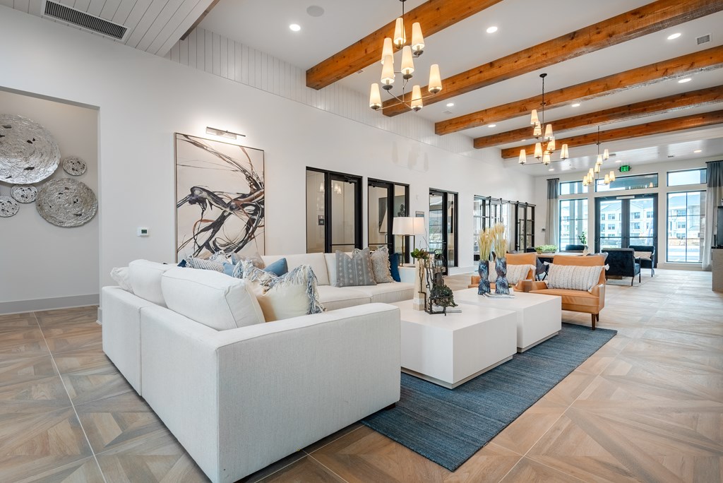 a living room with white couches and a rug