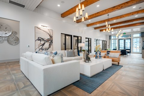 a living room with white couches and a rug