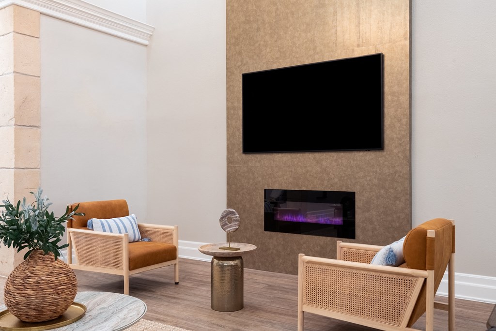 a living room with two chairs and a fireplace  at Hayden on West Ave, San Antonio, Texas