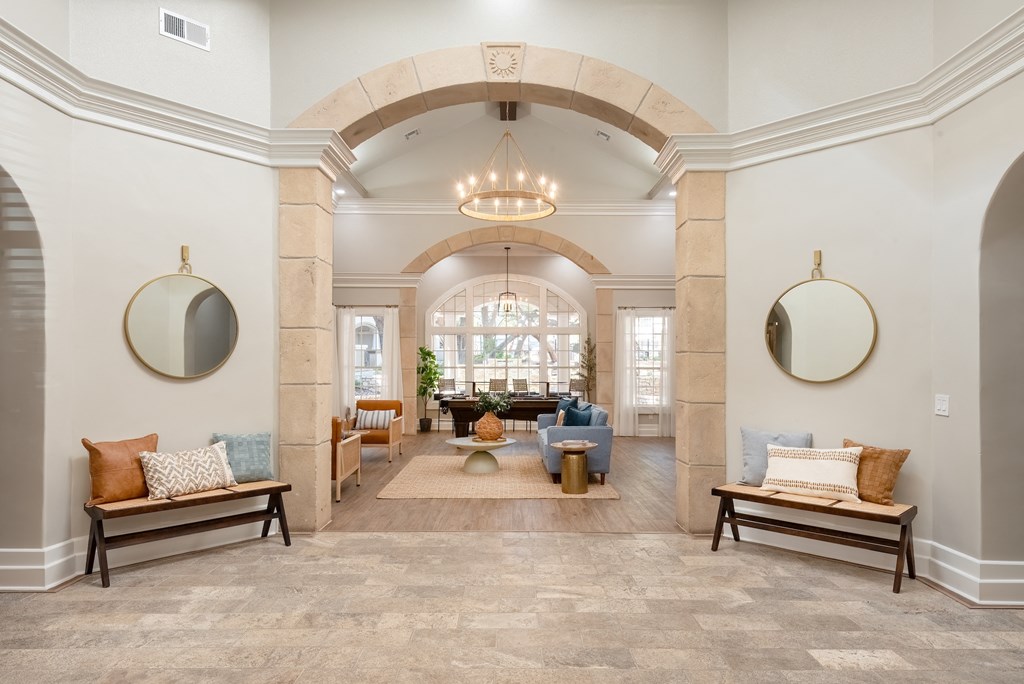 a living room with an arched ceiling and a lobby with seating and a table  at Hayden on West Ave, San Antonio, 78216