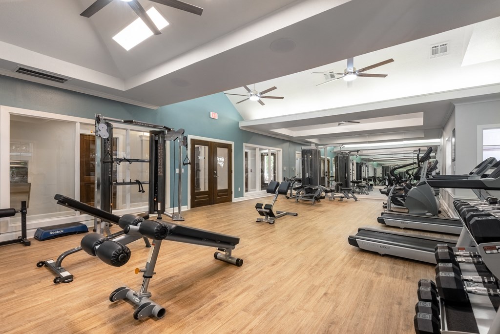 2200 sq ft gym with cardio equipment and weights on a wood floor  at Hayden on West Ave, San Antonio