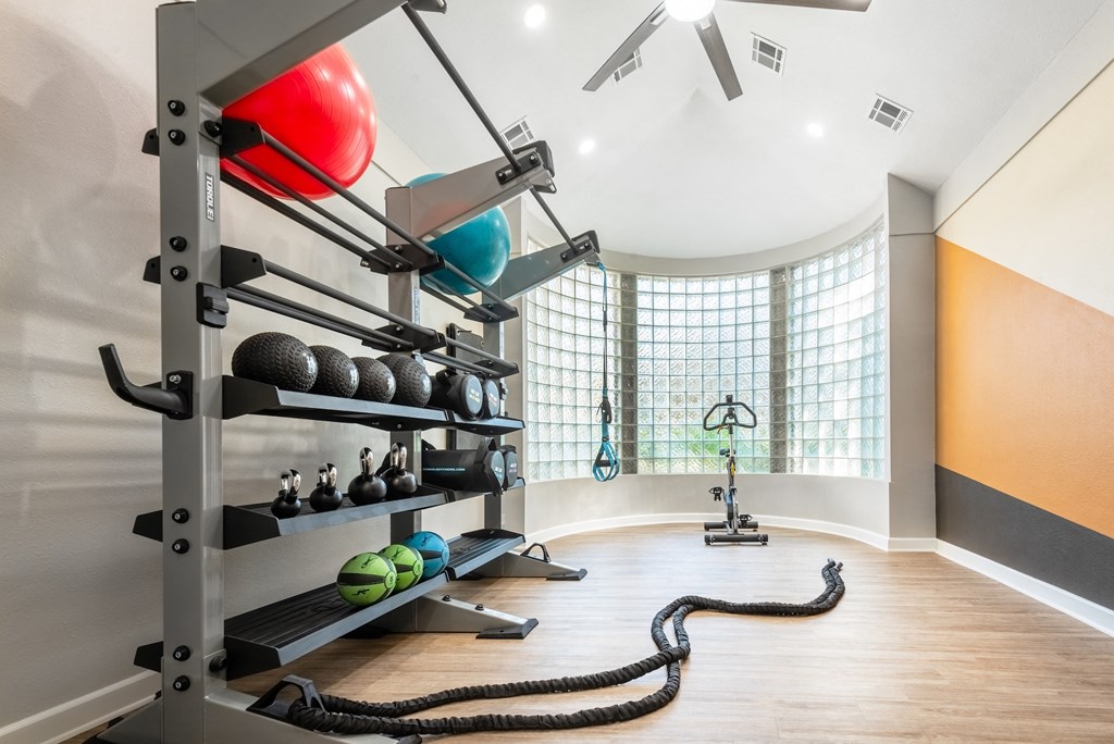 a workout room with weights and a gym ball on the floor and a large window  at Hayden on West Ave, San Antonio
