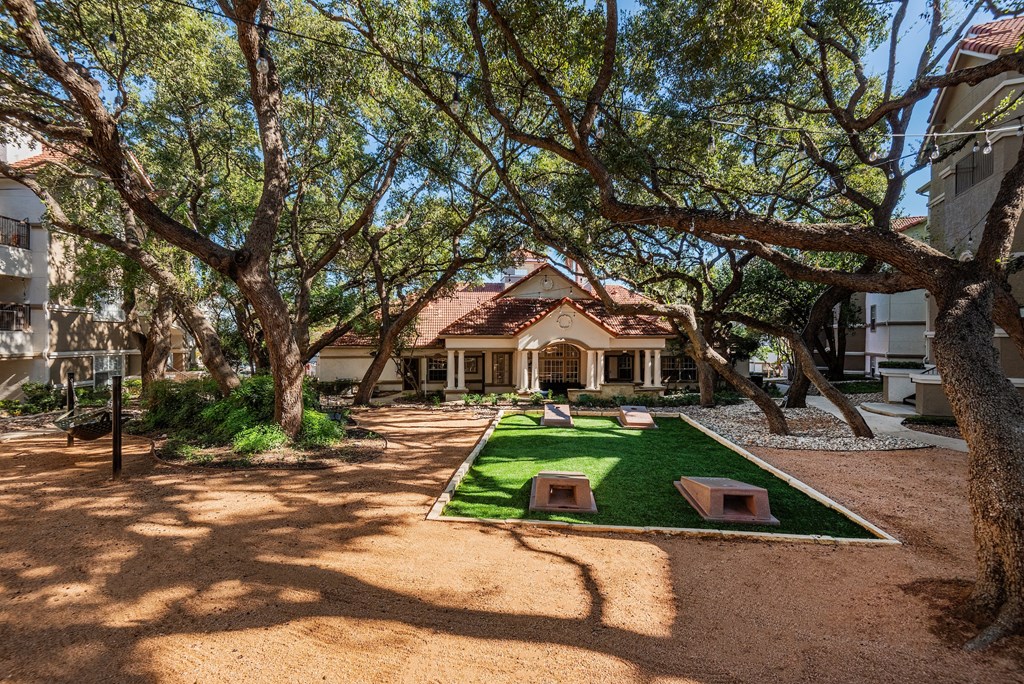 a courtyard with grass and trees in front of a house  at Hayden on West Ave, San Antonio, Texas