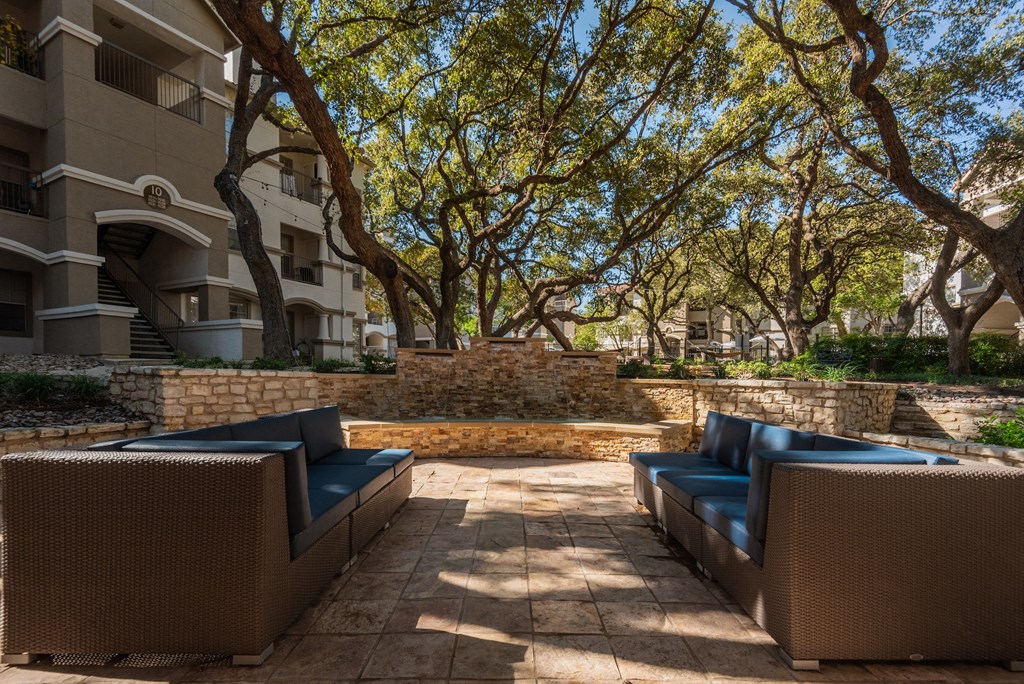 a patio with furniture in front of an apartment building  at Hayden on West Ave, San Antonio, TX, 78216