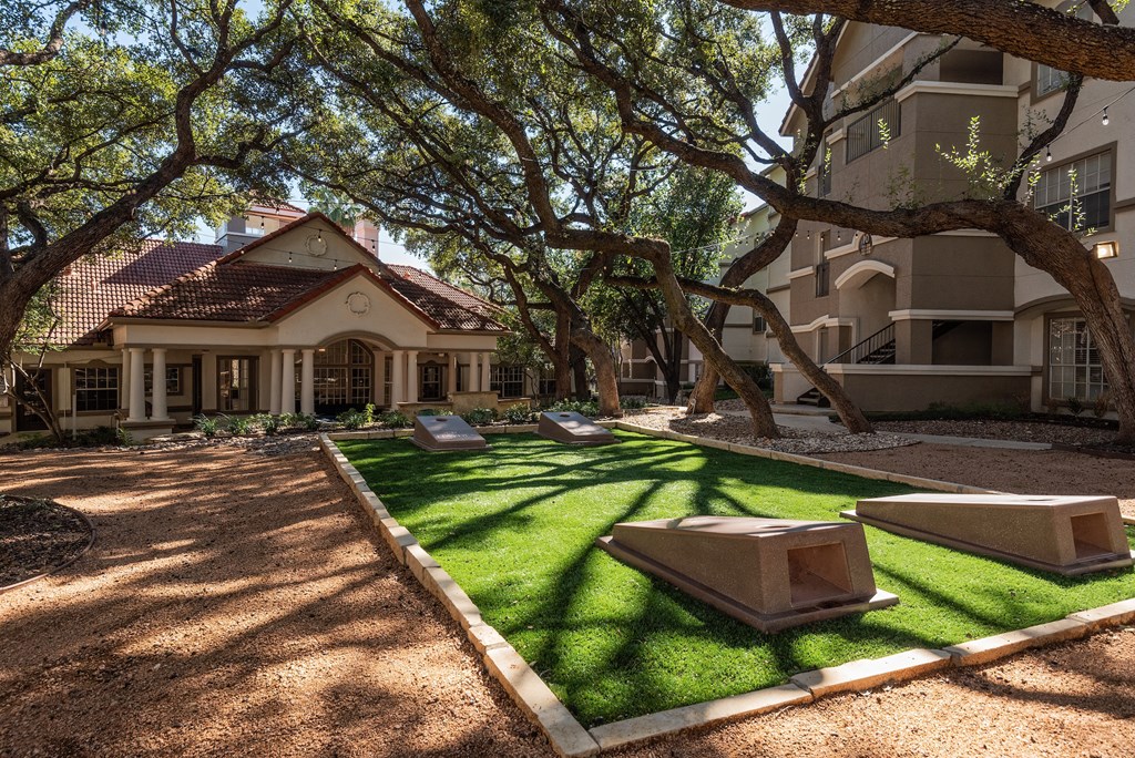 a courtyard with grass and trees in front of a building  at Hayden on West Ave, San Antonio, Texas