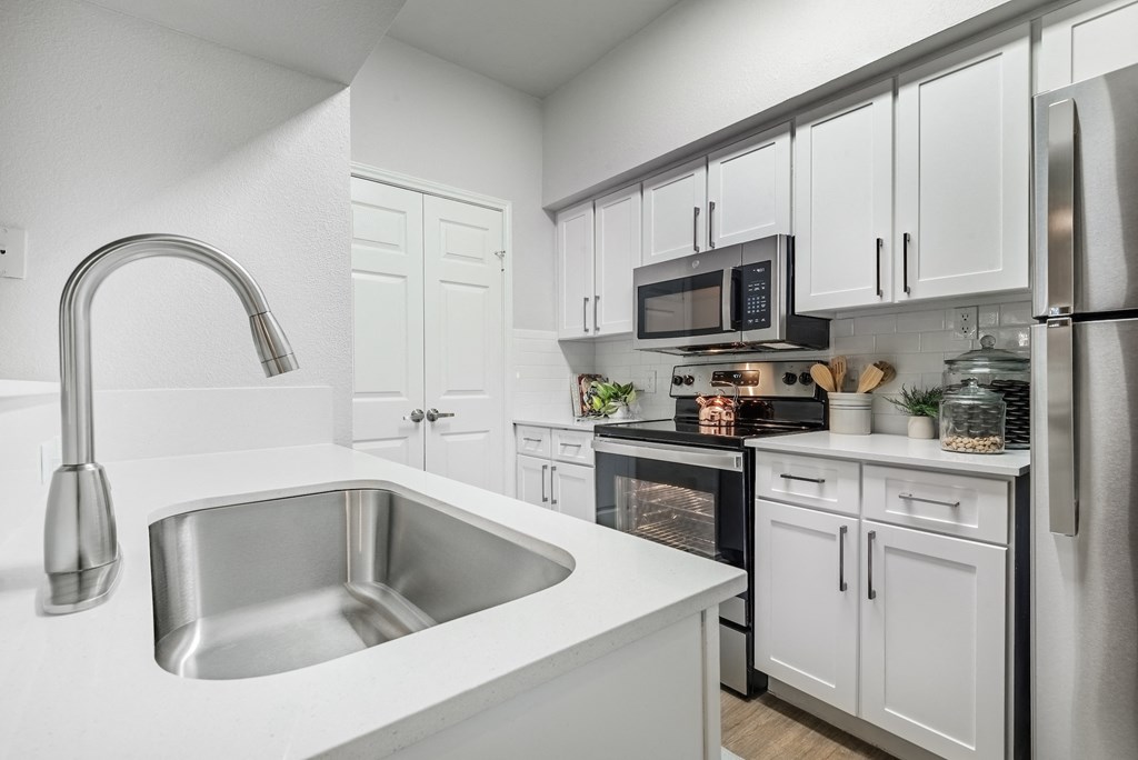 our spacious kitchen is equipped with stainless steel appliances and white cabinets  at Hayden on West Ave, San Antonio, 78216