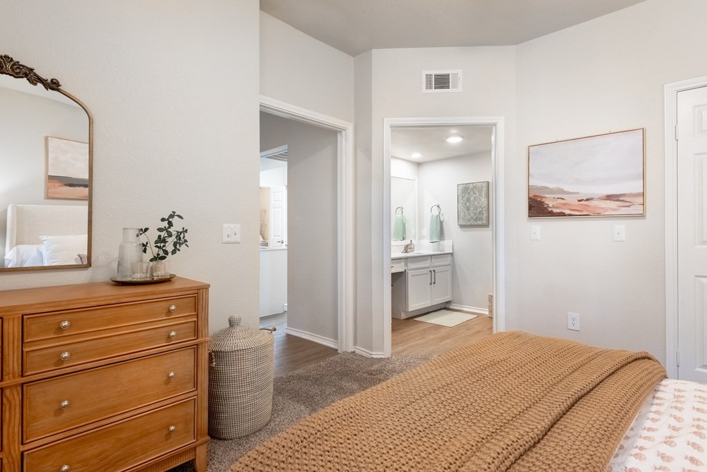 a bedroom with a bed and a dresser and a bathroom  at Hayden on West Ave, San Antonio, TX