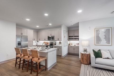 A modern kitchen with a dining table and chairs.