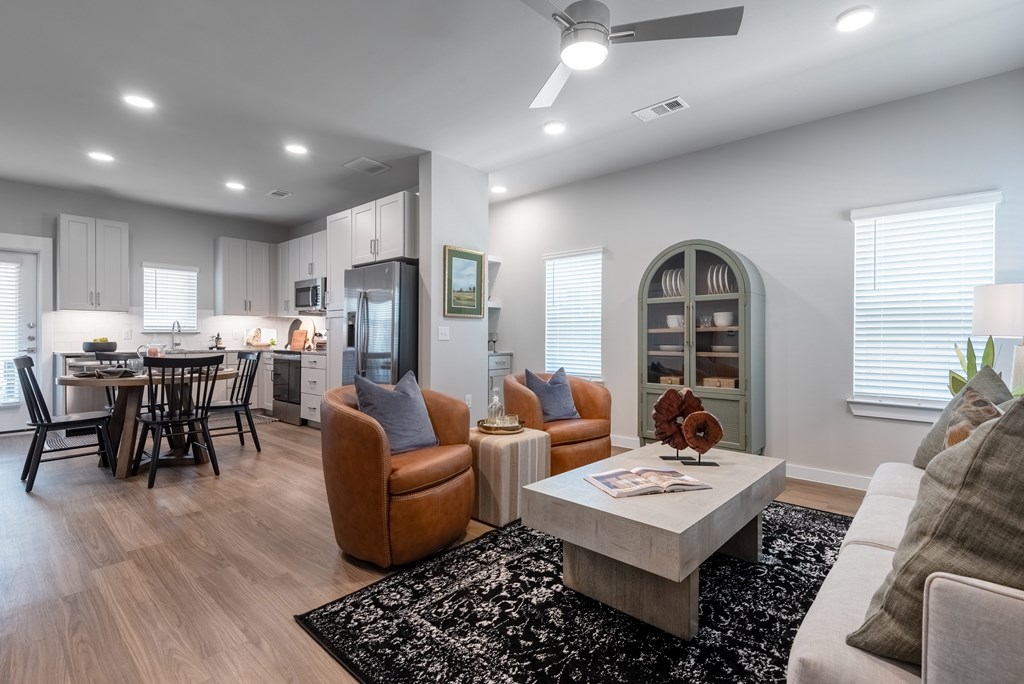 A modern living room with a brown leather chair and a white coffee table.