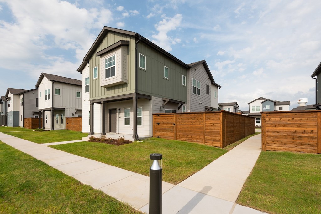 A row of houses with a black post in the foreground.