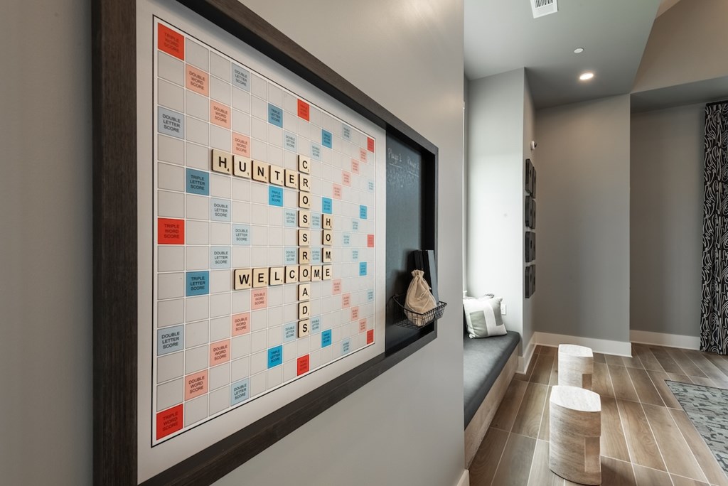 A framed board game with the words "Hunter" and "Welcome" spelled out on it.