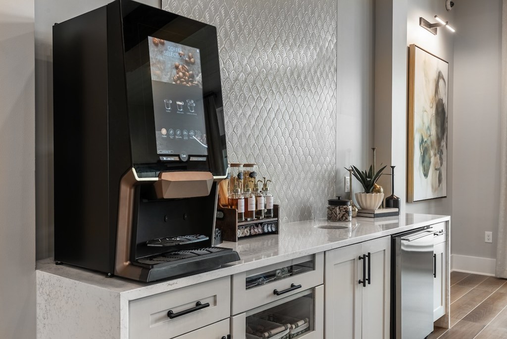 A modern kitchen with a black oven and white cabinets.