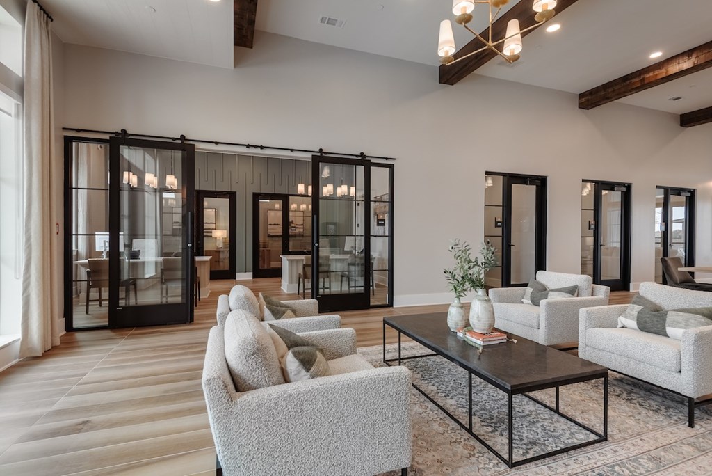 A modern living room with a glass door wall and a black coffee table.