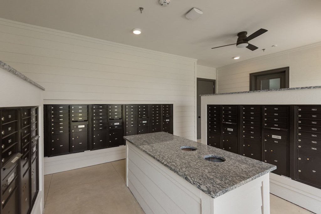 A kitchen with a granite countertop and black cabinets.
