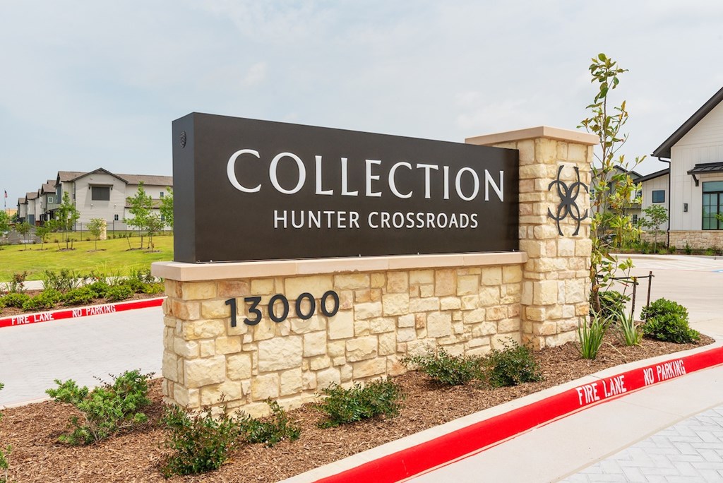A sign for Collection Hunter Crossroads stands in front of a building.