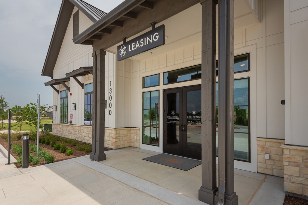 The front of a building with a leasing sign on it.