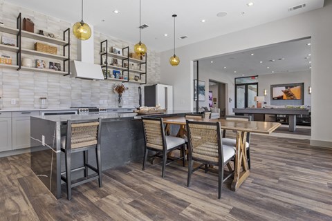 A modern kitchen with a dining table and chairs.