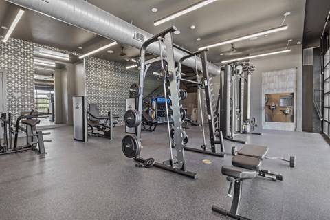 a gym with weights and other exercise equipment in a building