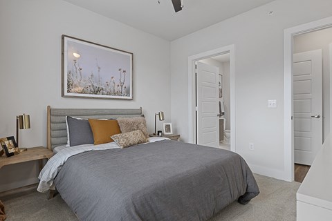 a bedroom with a bed and a door to a bathroom