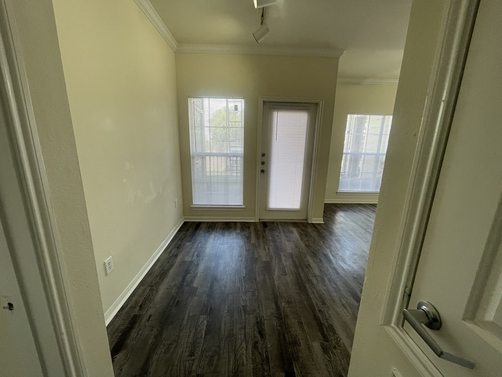 A room with wooden floors and white walls.