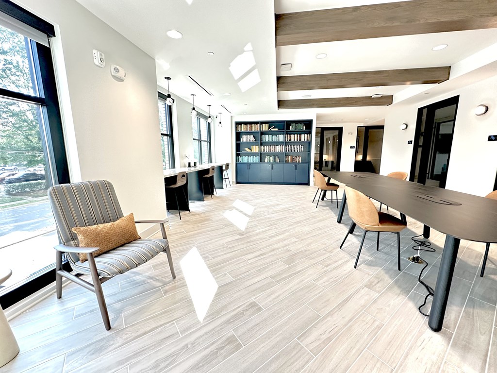 A modern office space with a long table and chairs.