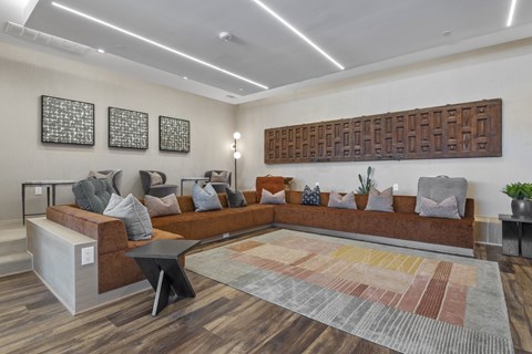 A modern living room with a large sectional sofa and a wooden wall panel.