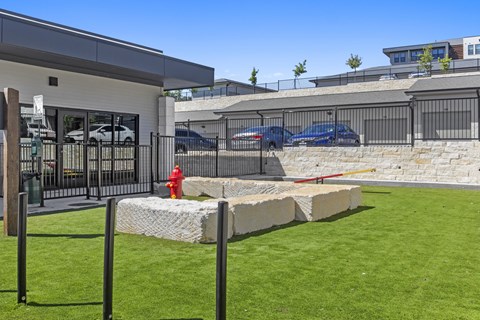 A modern building with a white exterior and a black fence.