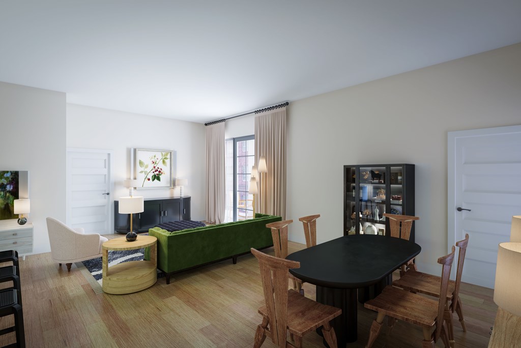 A living room with a fireplace, a green couch, and a black table.