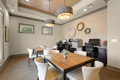 a dining room with a table and chairs and a computer desk