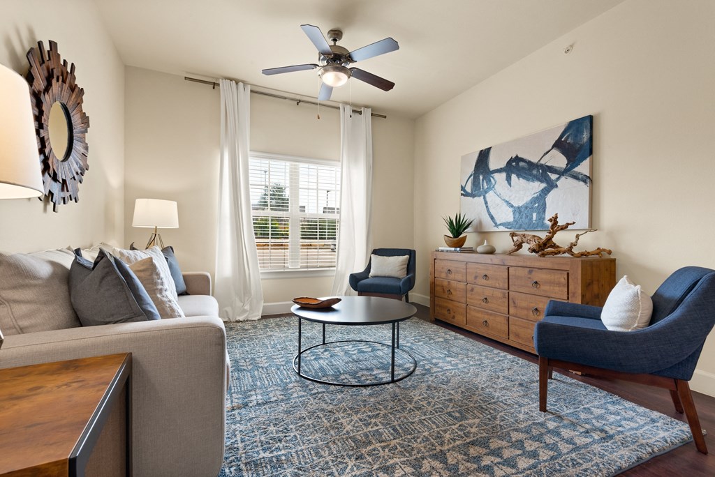 an open living room with a ceiling fan and a window