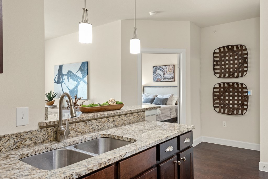 an empty kitchen with a sink and a counter top