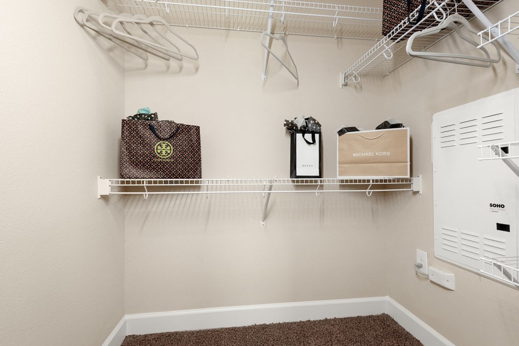 spacious laundry room with hooks and shelves and a washer and dryer