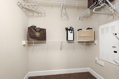 spacious laundry room with hooks and shelves and a washer and dryer