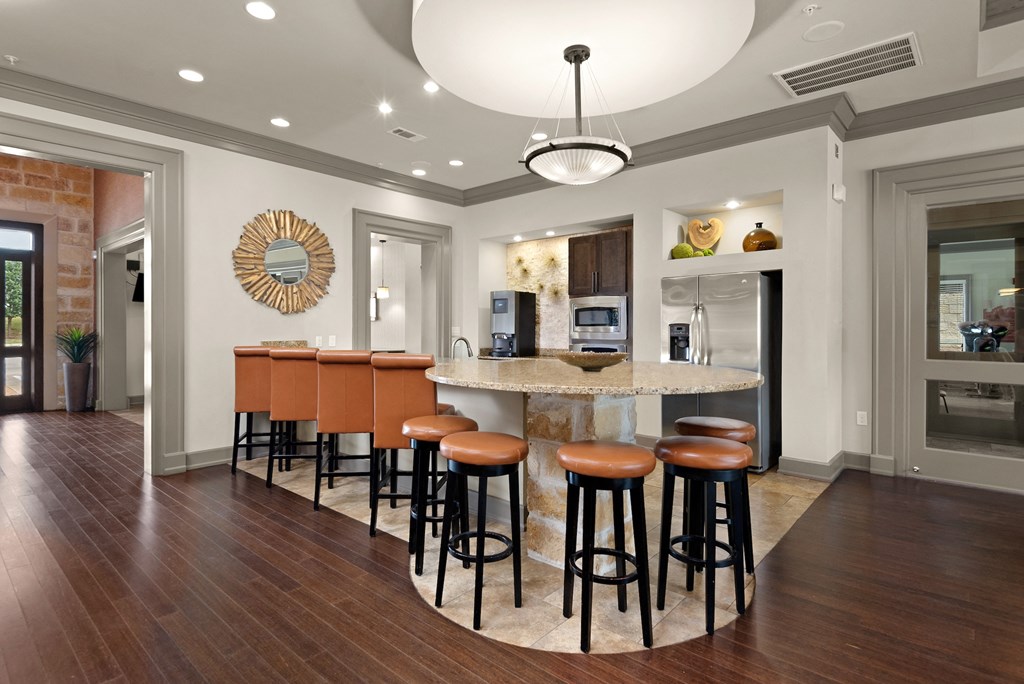 a kitchen with a large island with bar stools