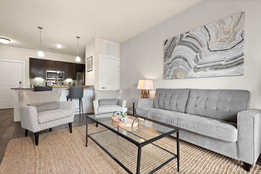 a living room with a couch and two chairs