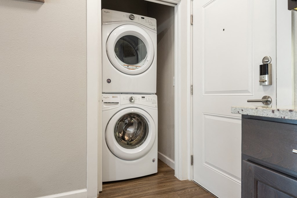 a front loading washer and dryer in a laundry room