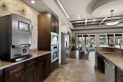 a large kitchen with stainless steel appliances and granite counter tops
