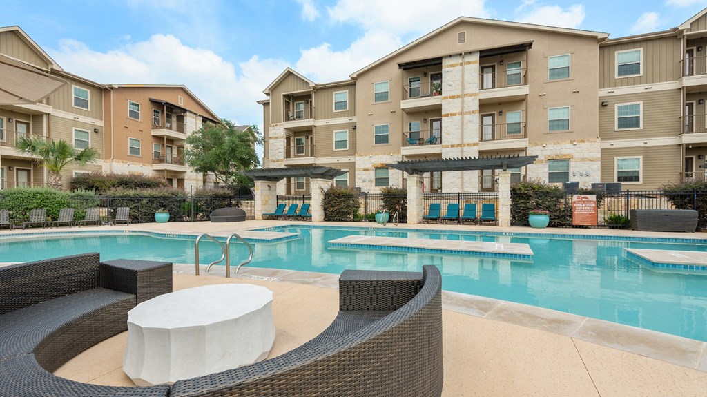 our apartments have a large swimming pool with chairs and tables
