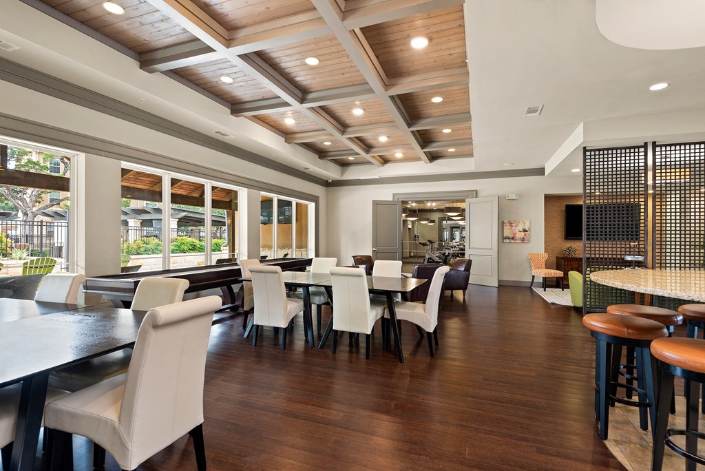 a dining room with tables and chairs and a large window