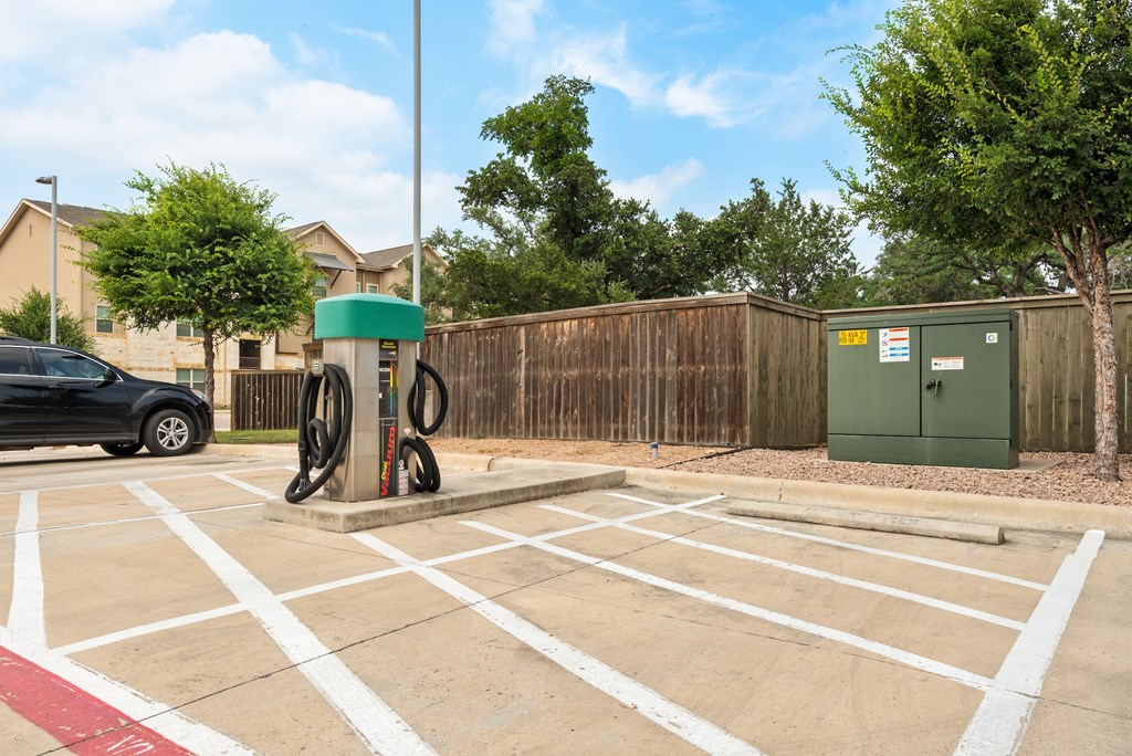 a gas pump in the middle of a parking lot