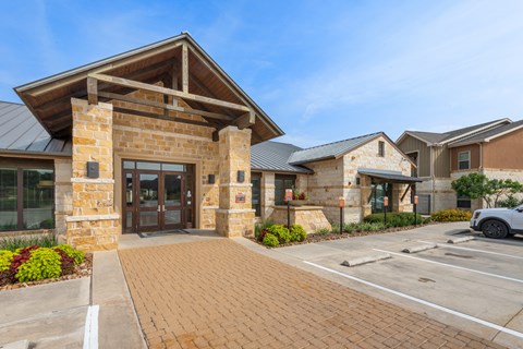 the entrance to a building with a car parked outside of it
