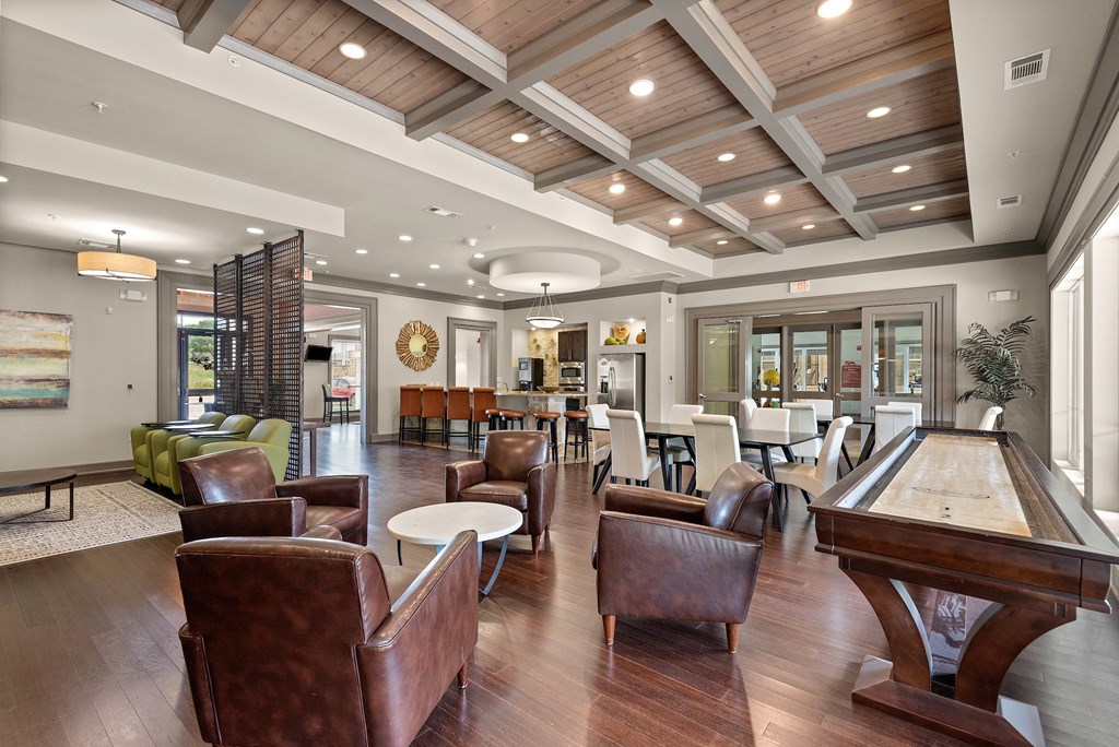 a clubhouse with a pool table and chairs